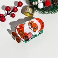 Detailed close-up of a Santa Claus hair claw clip on a festive Christmas themed background - Plastic / Christmas Acrylic Standing Santa