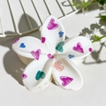 White frangipani hair claw with colorful heart graffiti patterns for stylish updo styling - White Heart Graffiti (141-9)
