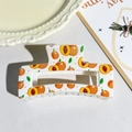 Checkerboard hair claw clip featuring an orange peach print on white acetate material - Orange Peach Pattern Style (147-5)