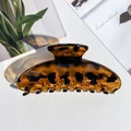 Macro detail of amber leopard print hair claw clip showing a translucent texture and smooth teeth - Square Shape / PS / Glossy Yellow Leopard