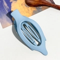 Macro shot of light blue matte banana hair clip with hollow oval design and curved texture - 11.5cm Oval Clip / Matte Sky Blue