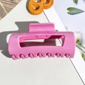 Detailed view of glossy pink soft silicone hair claw clip on a stylish lifestyle background - 10.5cm Deep Pink