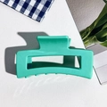 Detail view of 8.5cm mint green square silicone hair claw clip on textured background - 8.5cm Peacock Green