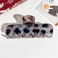 Close-up of a tortoiseshell acetate hair claw clip with dark spots on a white surface - 11cm Rectangular Gray Leopard Glossy