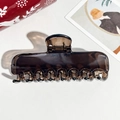 Macro shot of translucent brown hair claw clip with multi-tooth design on leather surface - 11cm Rectangular Transparent Dark Coffee