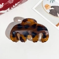 Detailed view of tortoiseshell resin hair claw clip with a glossy translucent finish - 9cm Handbag Style Coffee Leopard Glossy