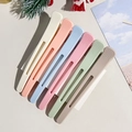 Detail view of 6 colorful hair root clips on card featuring non-slip grip and hollow design - Style A / Macaron Color