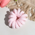 Close-up of pink plush spiral hair tie with a soft texture on textured background - Spiral Structure (20251108b) / Solid Light Pink