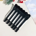Set of six black cosmetic spatulas for cream application on elegant textured background - Style B / Black