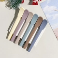 Detailed view of the 6-piece plastic spatula set in various earthy pastel colors on white - Style B / Morandi Color