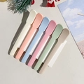 Close-up of 6-piece colorful plastic spatulas for cosmetics on a festive background - Style B / Macaron Color