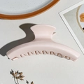 Macro detail of the large soft pink matte finish hair claw clip on a textured surface - Glossy Pink