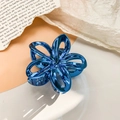 Detail of blue electroplated hollow plumeria hair claw clip with metallic finish - 7.5cm / Metallic Peacock Blue