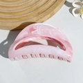 Macro detail of half-moon hair claw clip with pink and white marble texture - Pink