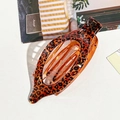 Leopard print curved hair claw clip in amber translucent acrylic for women hairstyles - Orange Leopard Print Oval Clip
