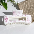 White rectangular hair claw clip with pink bow patterns on a textured background - Pink Bow Print (142-2)