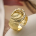 Macro shot of gold-plated textured band ring with sparkling pavé zircon crescent detail - Horseshoe Vertical Stripe Style (14344)