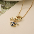 Macro shot of 18K gold plated celestial pendant necklace with colorful cubic zirconia - Moon Saturn Star (24973) / Gold