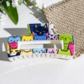 Square hair claw clip featuring colorful cartoon cat print on a white leather surface - Lively Multicolor Cats (150-1) / ABS