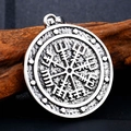 Detailed macro view of silver Viking Vegvisir compass pendant on a natural wood surface - Compass Rivet Style (BP8-276)