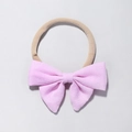 Detail of pink bow baby headband made of textured cotton linen with elastic nylon band - Pink Textured