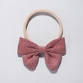 Infant headband with red textured bow and soft nude nylon elastic band for baby girls - Red