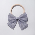 Detail of baby headband with a black and white striped bow on soft nylon fabric - Black & White Stripes