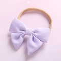 Fascia per capelli neonato con fiocco lavanda e morbido elastico in nylon su sfondo rosa - Viola