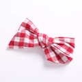 Close-up of red and white gingham fabric texture on a handmade cotton linen hair bow - Pink Plaid