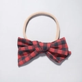 Detailed macro view of red black buffalo plaid bow on soft nude nylon baby headband - Red Black Buffalo Plaid Style (12)