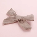 Detail of handmade cotton bow hair clip featuring soft fabric texture and dusty pink color - Dark Khaki