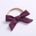 Detail of purple cotton bow headband with white stars and soft nylon band for babies - Deep purple