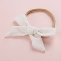 Diadema para bebé de nailon con lazo de lino blanco sobre fondo rosa pastel - Blanco