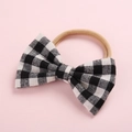 Soft nylon baby headband featuring a black and white plaid bow decoration - Black Plaid