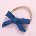 Detailed view of blue corduroy bow baby headband with high-stretch nylon elastic band - Denim Blue