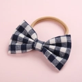 Detail of navy gingham bow on soft nylon baby headband with gentle elastic texture - Navy Plaid