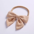 Close-up of beige linen bow headband with soft stretch nylon band for baby girls - Khaki