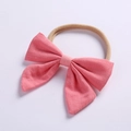 Detail showing pink linen bow and soft seamless nylon headband for infants and girls - Watermelon red