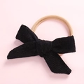 Detailed view of a black corduroy bow baby headband with elastic stretchy band - Black