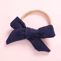 Detailed shot of dark blue corduroy bow knot on a highly elastic baby headband - Navy Blue