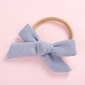 Close-up of baby headband with blue corduroy glitter bow and nylon elastic band - Light Blue