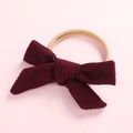Close-up of wine red corduroy bow with high elasticity nylon band for newborns - Burgundy