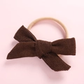 Detail view of coffee corduroy bow headband with soft nude seamless elastic band - Brown