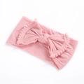 Close-up of pink baby nylon headband with large bow and soft pom pom lace edges - Dusty Pink