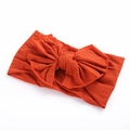 Bandeau souple en nylon orange brûlé pour bébés avec un grand nœud décoratif sur le dessus - Orange