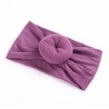 Detailed close-up of a lilac elastic nylon headband with a sweet donut-shaped knot for babies - 12 Light Purple