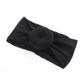 Close-up of soft black nylon baby headband featuring a donut knot design and stretchy fabric - 7 Black