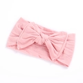 Detailed view of pink elastic baby headband with soft knitted texture and large bow - Dusky Pink