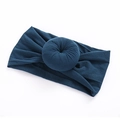 Detail of teal nylon headband with donut knot showing the soft elastic fabric texture - 9 Dark Blue