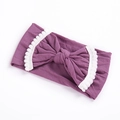Purple elastic baby headband with large bow and white pom-pom trim on white background - Light Purple
